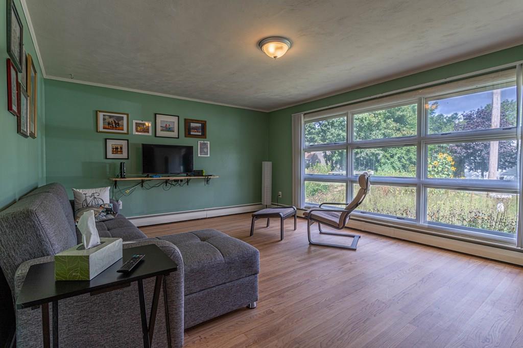 202 Whalom Road Lunenburg, MA 01462 - Photo 13 of 42 a living room with furniture and a flat screen tv