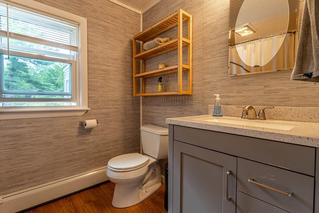 202 Whalom Road Lunenburg, MA 01462 - Photo 15 of 42 a bathroom with a toilet sink vanity and mirror