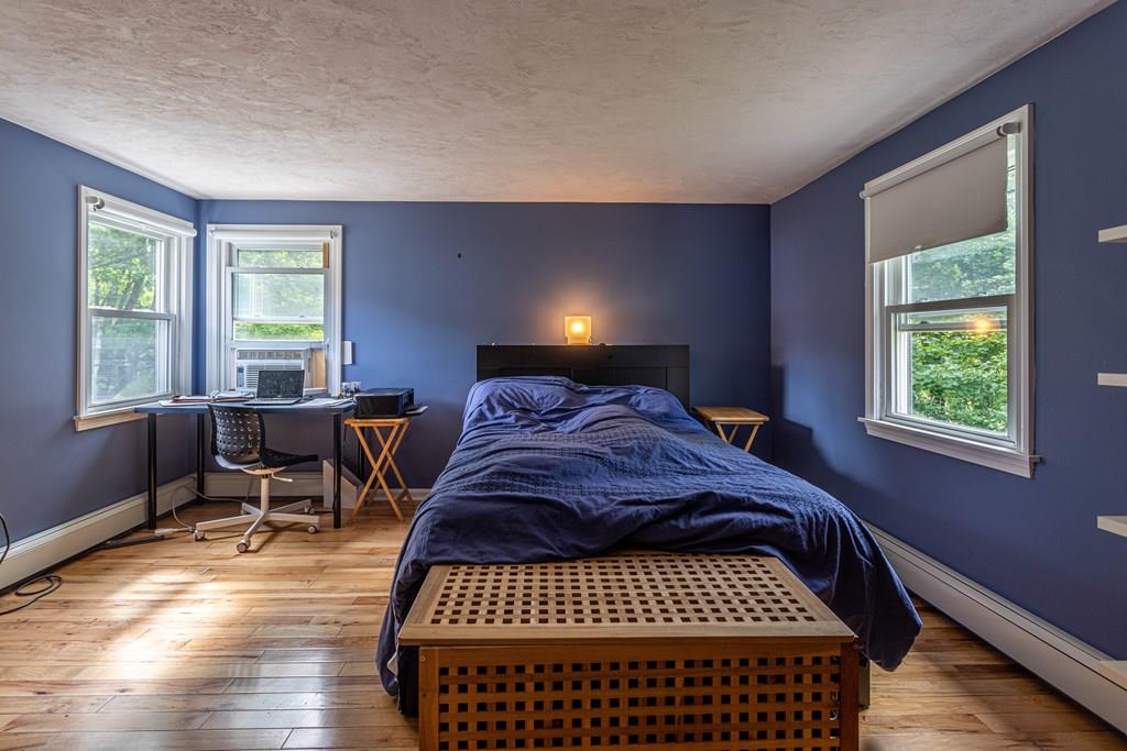 202 Whalom Road Lunenburg, MA 01462 - Photo 19 of 42 a bed sitting in a bedroom next to a window