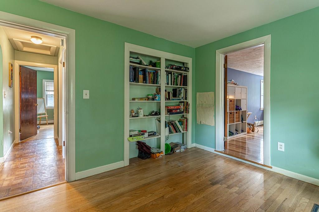 202 Whalom Road Lunenburg, MA 01462 - Photo 21 of 42 an empty room with closet and wooden floor
