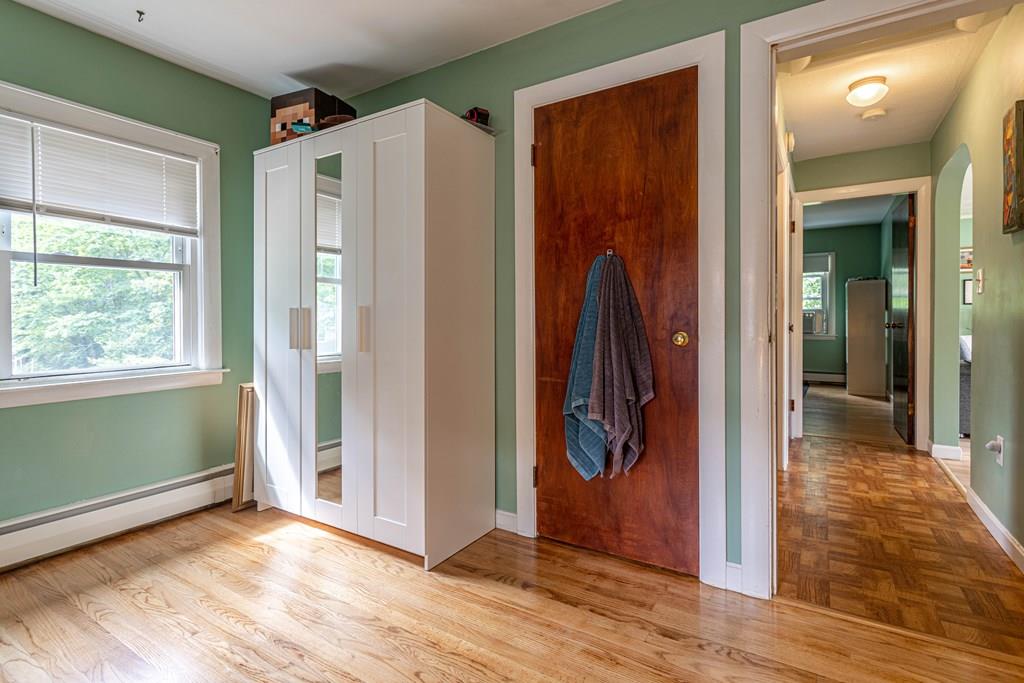 202 Whalom Road Lunenburg, MA 01462 - Photo 23 of 42 a view of a hallway with wooden floor and a living room