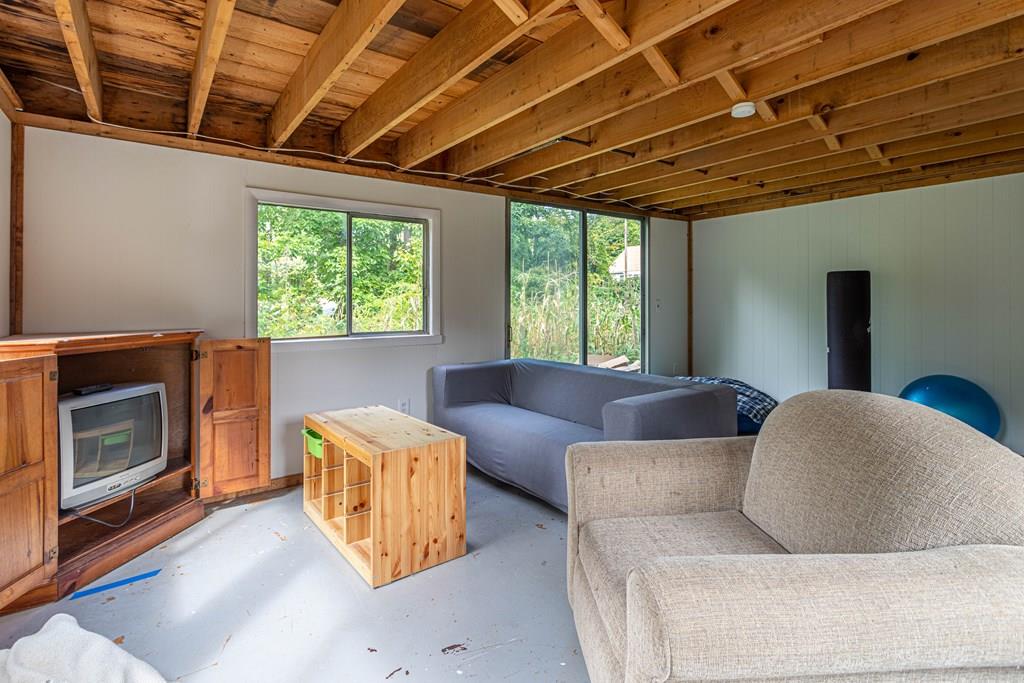 202 Whalom Road Lunenburg, MA 01462 - Photo 26 of 42 a living room with furniture and a fireplace