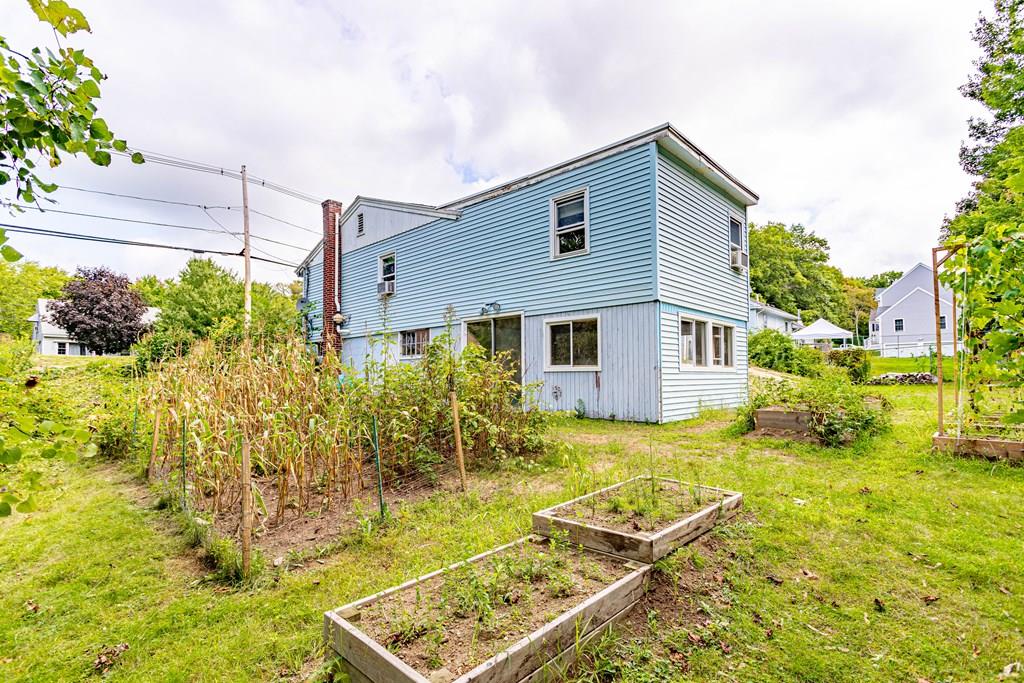 202 Whalom Road Lunenburg, MA 01462 - Photo 39 of 42 a backyard of a house with table and chairs