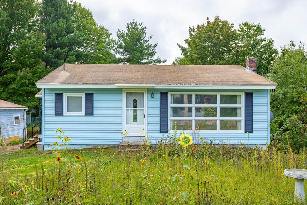 202 Whalom Road Lunenburg, MA 01462 - Photo 42 of 42 a front view of a house with a yard table and chairs