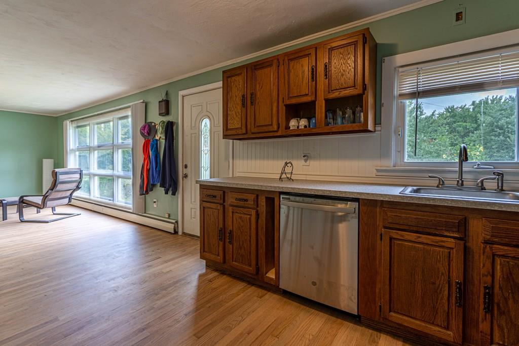 202 Whalom Road Lunenburg, MA 01462 - Photo 8 of 42 a kitchen with stainless steel appliances granite countertop a sink and wooden cabinets