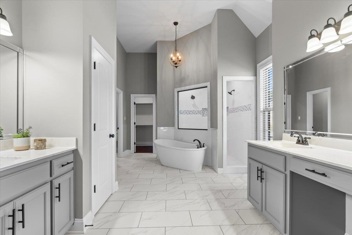1739 Treestand Road Southaven, MS 38672 - Photo 11 of 27 a spacious bathroom with a double vanity sink toilet mirror and bathtub