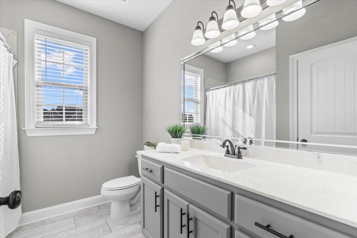 1739 Treestand Road Southaven, MS 38672 - Photo 17 of 27 a bathroom with a sink a toilet and a mirror