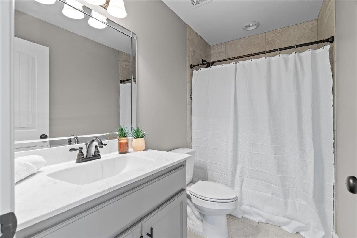 1739 Treestand Road Southaven, MS 38672 - Photo 20 of 27 a bathroom with a sink a toilet and shower curtain