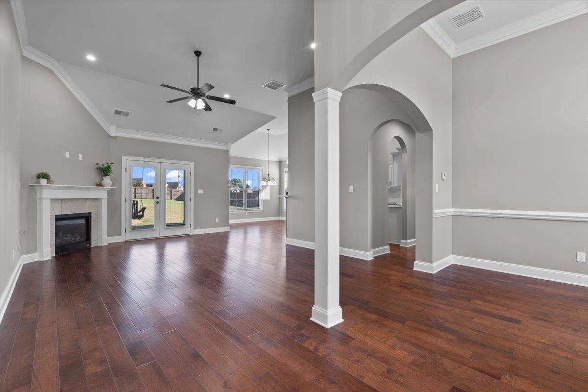 1739 Treestand Road Southaven, MS 38672 - Photo 3 of 27 an empty room with wooden floor fireplace and windows