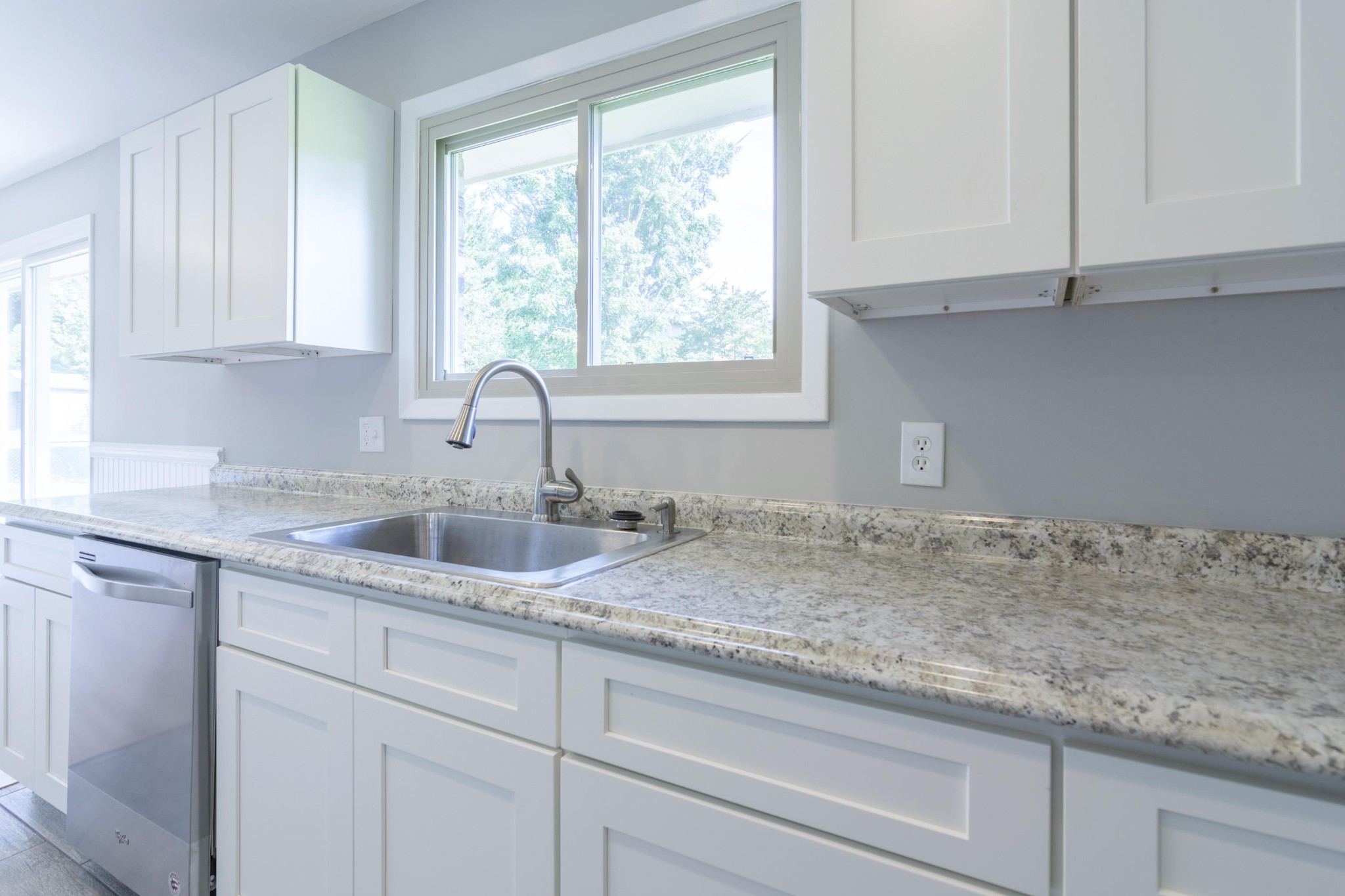 4309 Royalview Road Knoxville, TN 37921 - Photo 12 of 29 a kitchen with granite countertop white cabinets and window