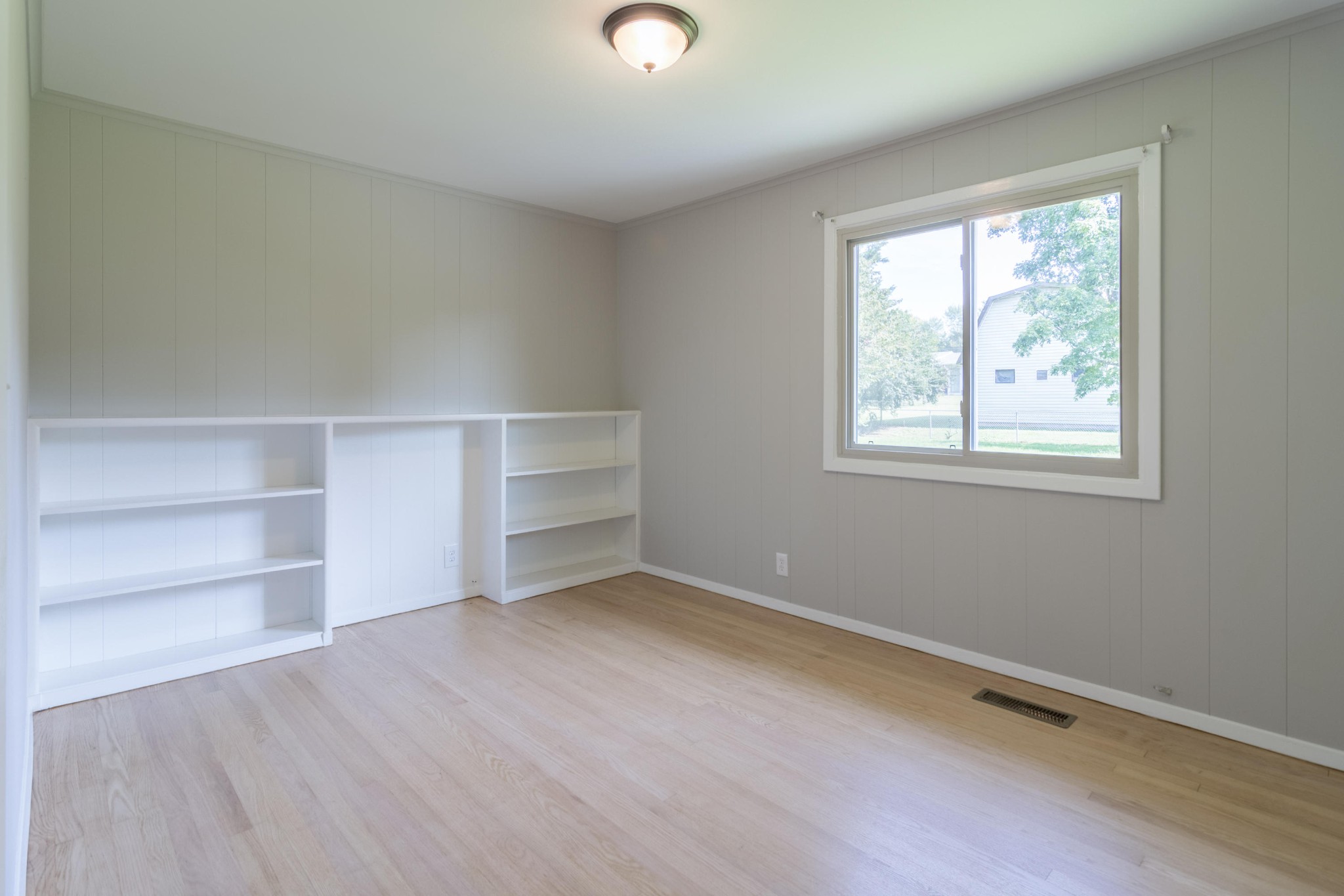 4309 Royalview Road Knoxville, TN 37921 - Photo 16 of 29 wooden floor in an empty room with a window