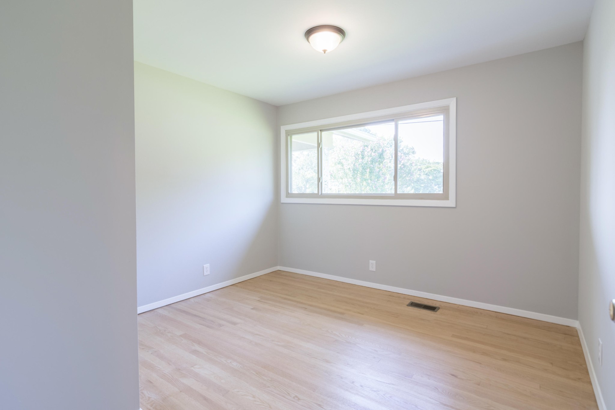 4309 Royalview Road Knoxville, TN 37921 - Photo 18 of 29 an empty room with wooden floor and windows