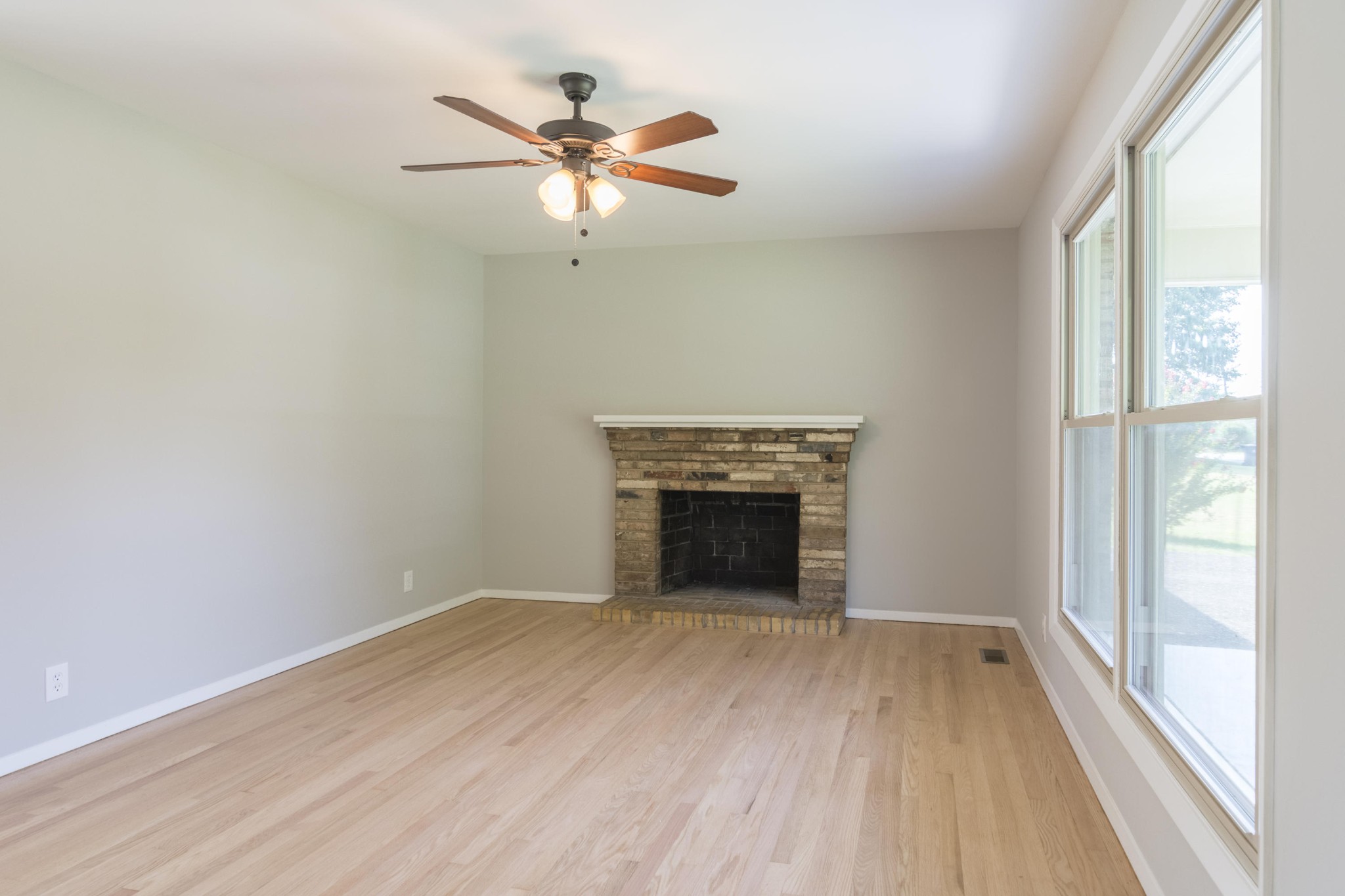 4309 Royalview Road Knoxville, TN 37921 - Photo 5 of 29 an empty room with wooden floor fan and windows