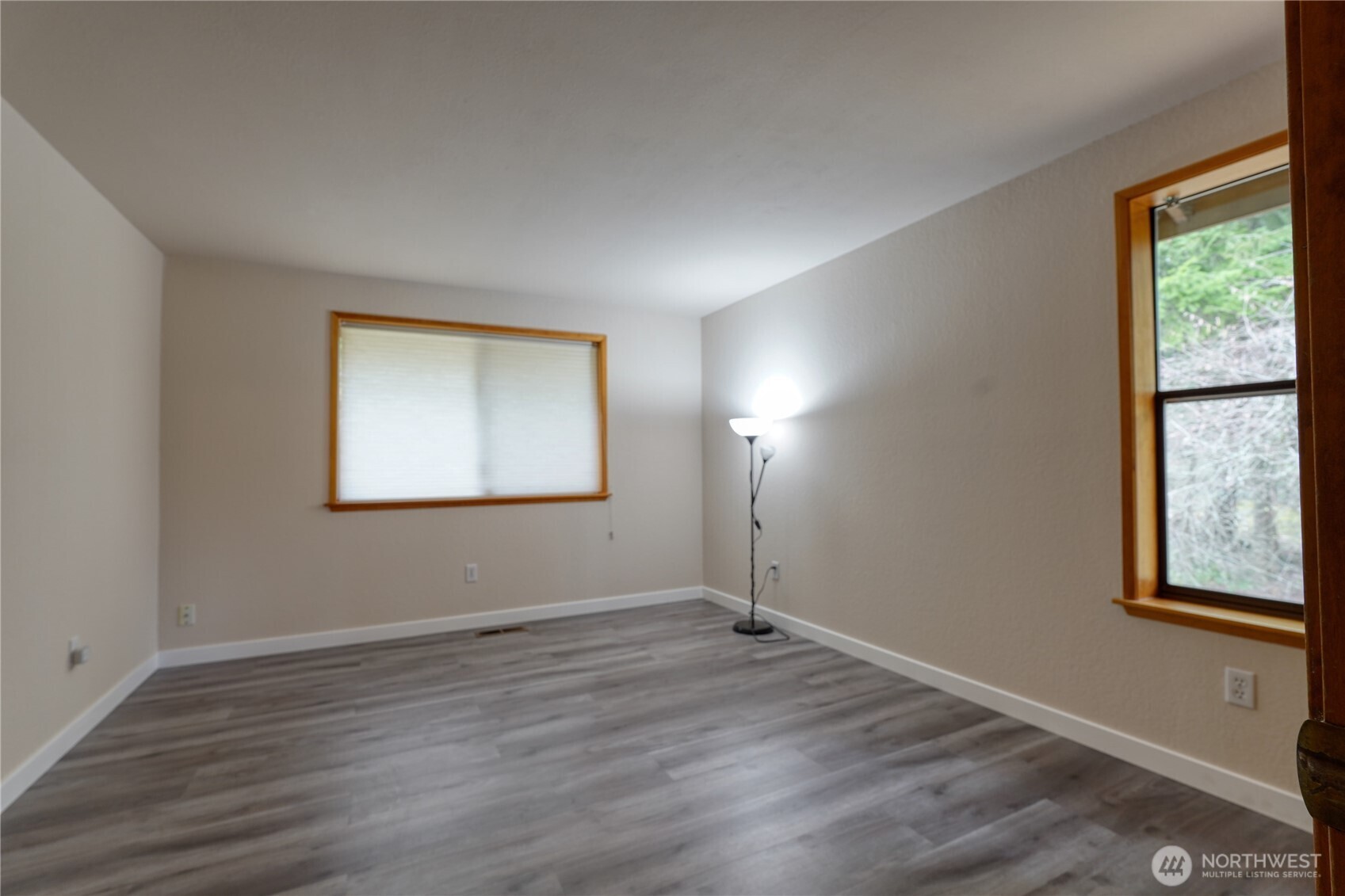 6511 255th St Court East Graham, WA 98338 - Photo 11 of 20 an empty room with wooden floor and windows
