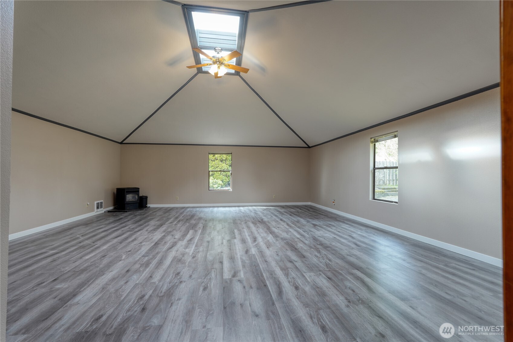 6511 255th St Court East Graham, WA 98338 - Photo 15 of 20 an empty room with wooden floor and windows