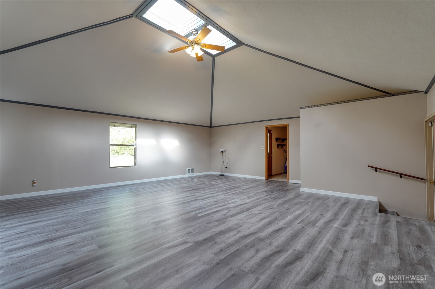6511 255th St Court East Graham, WA 98338 - Photo 16 of 20 an empty room with wooden floor chandelier fan and windows