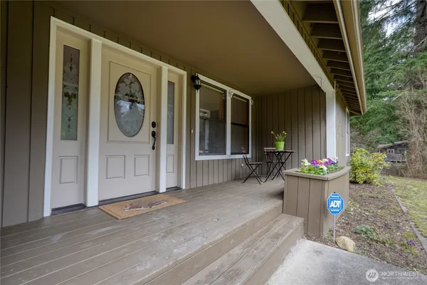 a view of a porch with garden and entryway