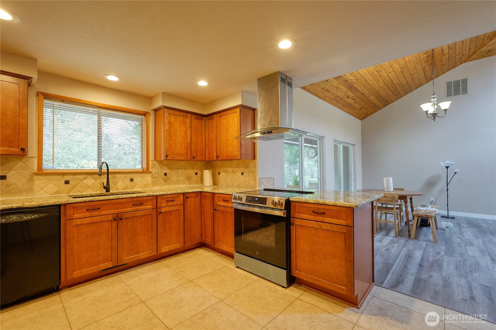 6511 255th St Court East Graham, WA 98338 - Photo 7 of 20 a kitchen with stainless steel appliances granite countertop sink stove top oven and cabinets