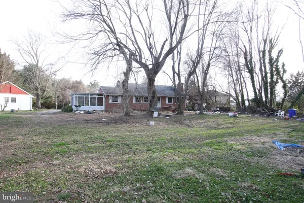 a view of a house with a yard covered in snow