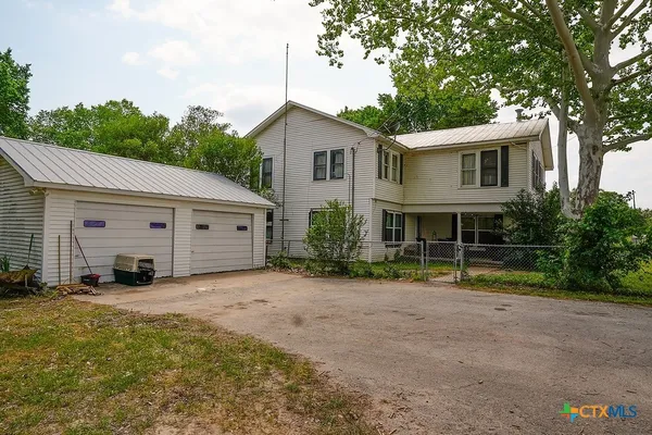 a view of a house with a yard and garage