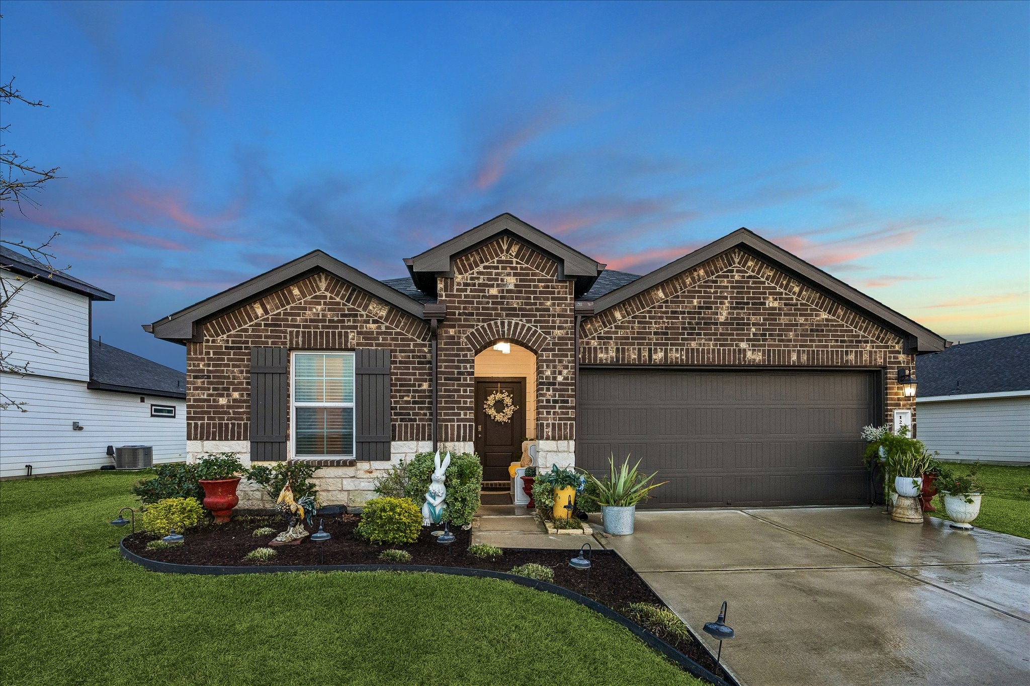 1237 Waterside Trace Sealy, TX 77474 - Photo 1 of 18 a front view of a house with garden
