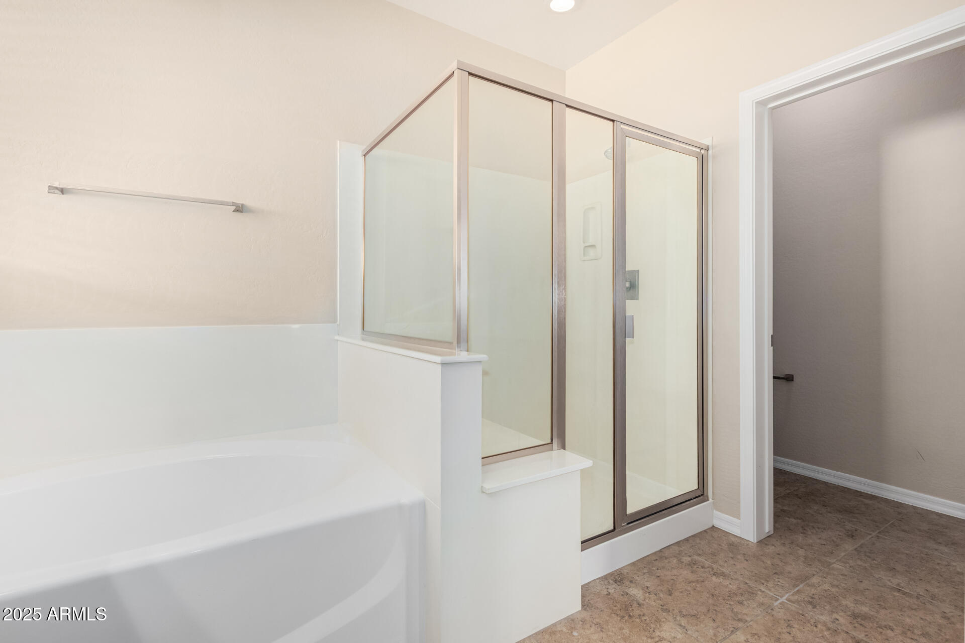 2530 West Gaby Road Phoenix, AZ 85041 - Photo 15 of 30 a bathroom with a bathtub and a shower