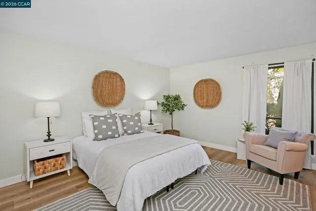 a bedroom with a bed mirror and window