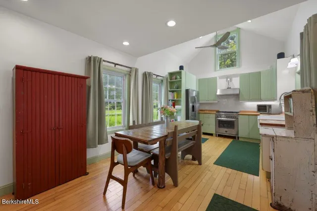 a kitchen with a stove top oven and refrigerator