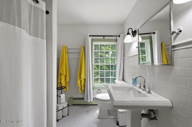 a view of a porch with wooden floor next to a yard