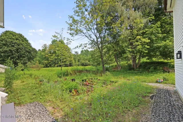a house with green field in front of it