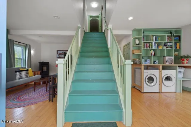 a view of entryway and hall with wooden floor