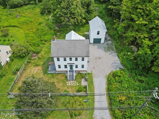 an aerial view of a house with a yard
