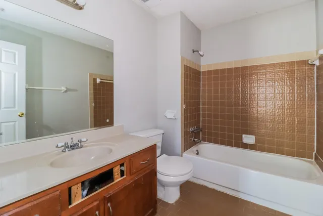 a bathroom with a sink a toilet and bathtub