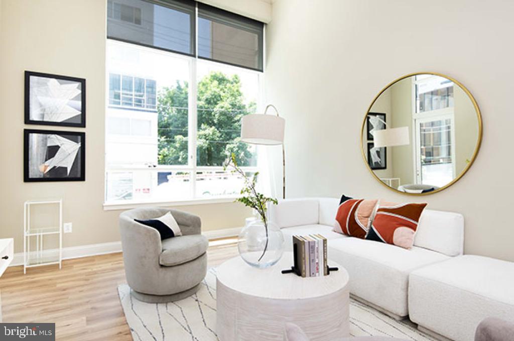 139-59 North 23rd Street, Unit 117 Philadelphia, PA 19103 - Photo 21 of 28 a living room with furniture and a mirror