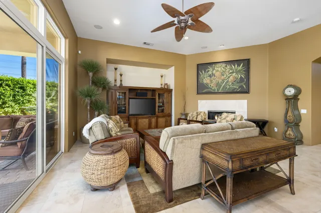 a living room with furniture and a floor to ceiling window