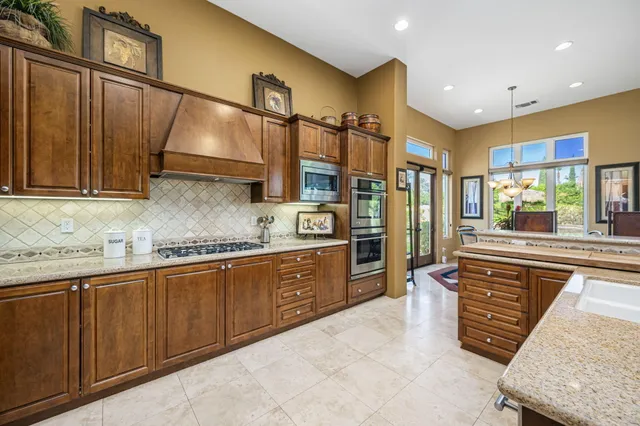 a view of a patio with furniture and a backyard
