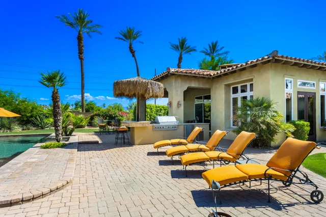 a spacious bedroom with a bed and a chandelier