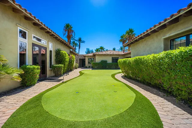 a bathroom with a granite countertop sink a toilet and mirror