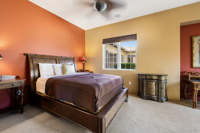 a view of a house with a yard and potted plants
