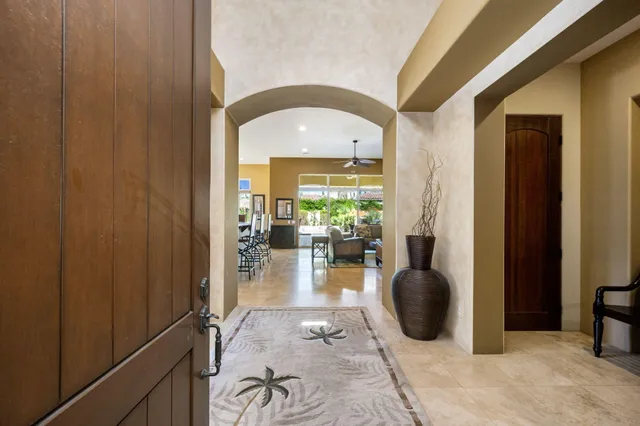 a kitchen with stainless steel appliances kitchen island granite countertop a refrigerator and microwave