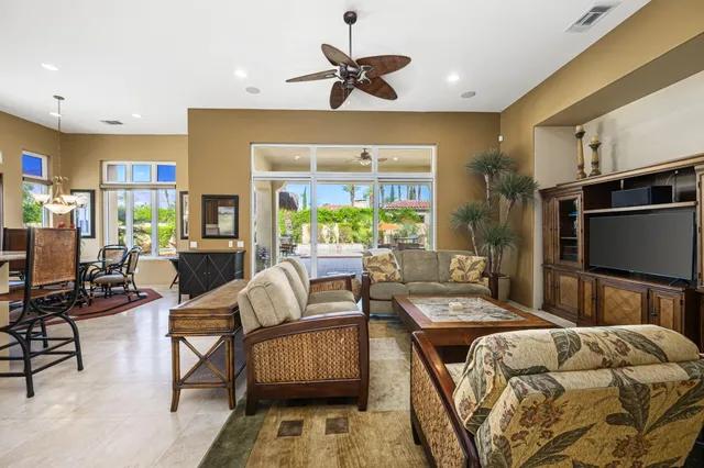 a view of a dining room with furniture large windows and wooden floor