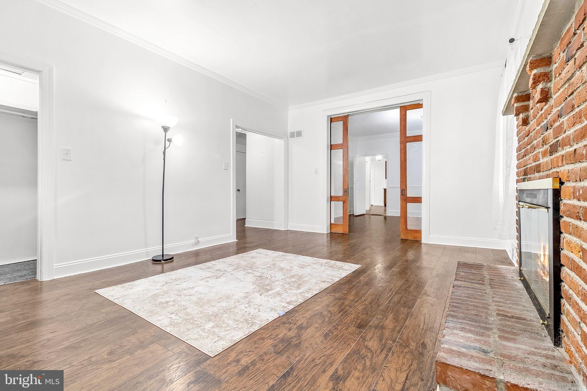 224 East Washington Street Riverside, NJ 08075 - Photo 5 of 27 Living room with natural sunlight & fireplace