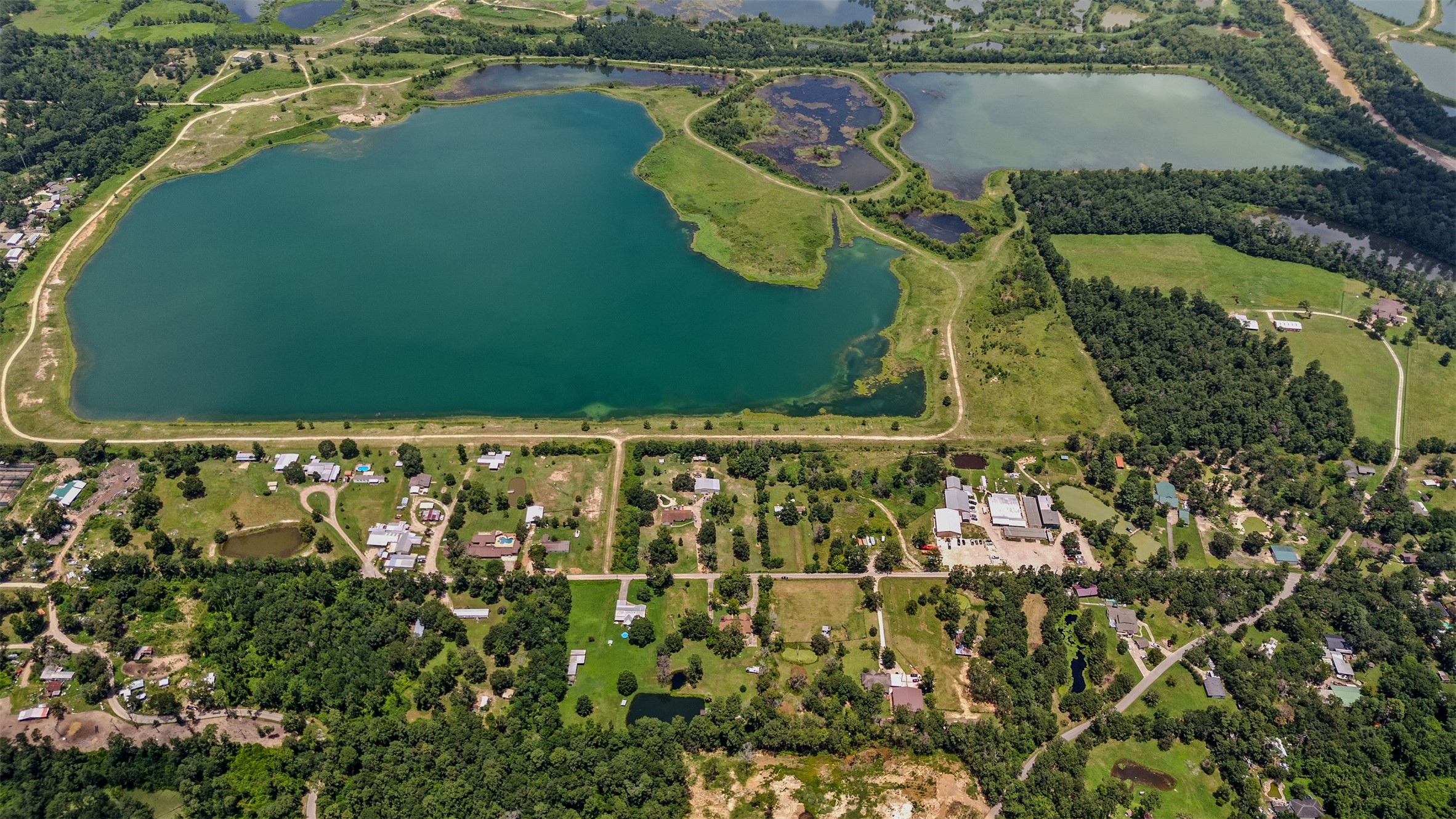 11692 Clark Lane Conroe, TX 77385 - Photo 31 of 35 Aerial view of the surrounding properties with a lake close by.