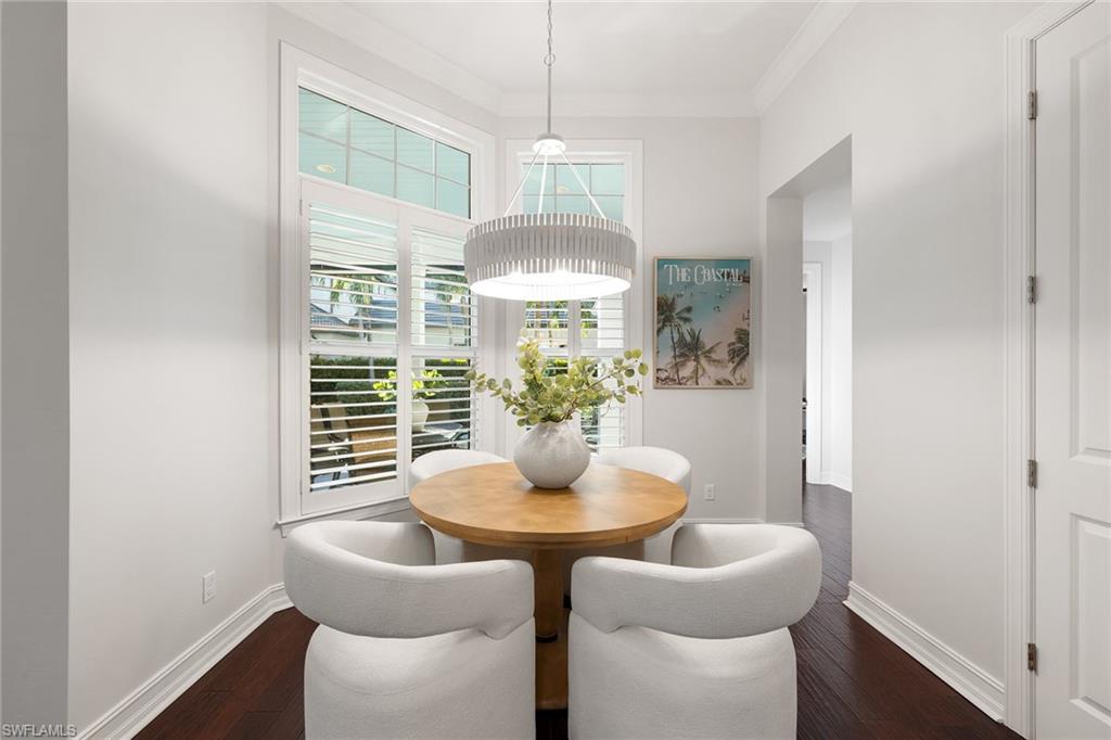 642 Bougainvillea Road Naples, FL 34102 - Photo 19 of 50 Dining room featuring dark wood-style floors and ornamental molding
