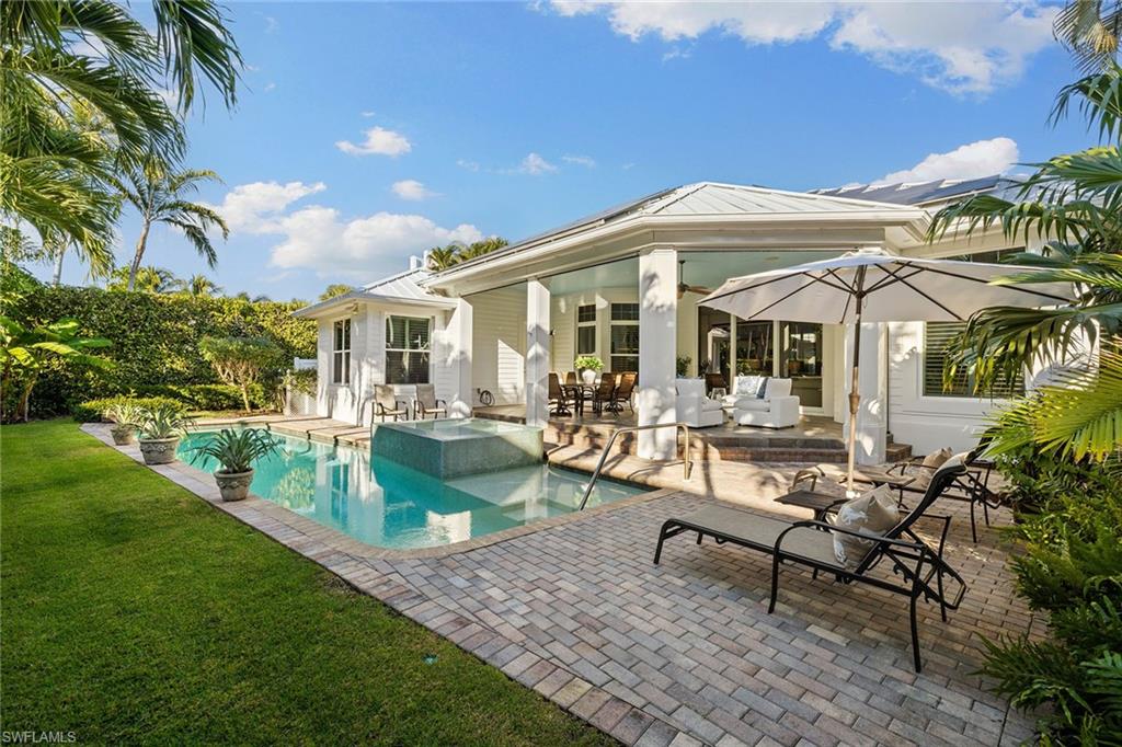 642 Bougainvillea Road Naples, FL 34102 - Photo 21 of 50 View of pool with a patio, a yard, outdoor dining area, an outdoor hangout area, and a pool with connected hot tub