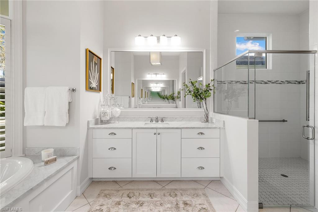 642 Bougainvillea Road Naples, FL 34102 - Photo 28 of 50 Full bathroom with vanity, a stall shower, and light tile patterned floors