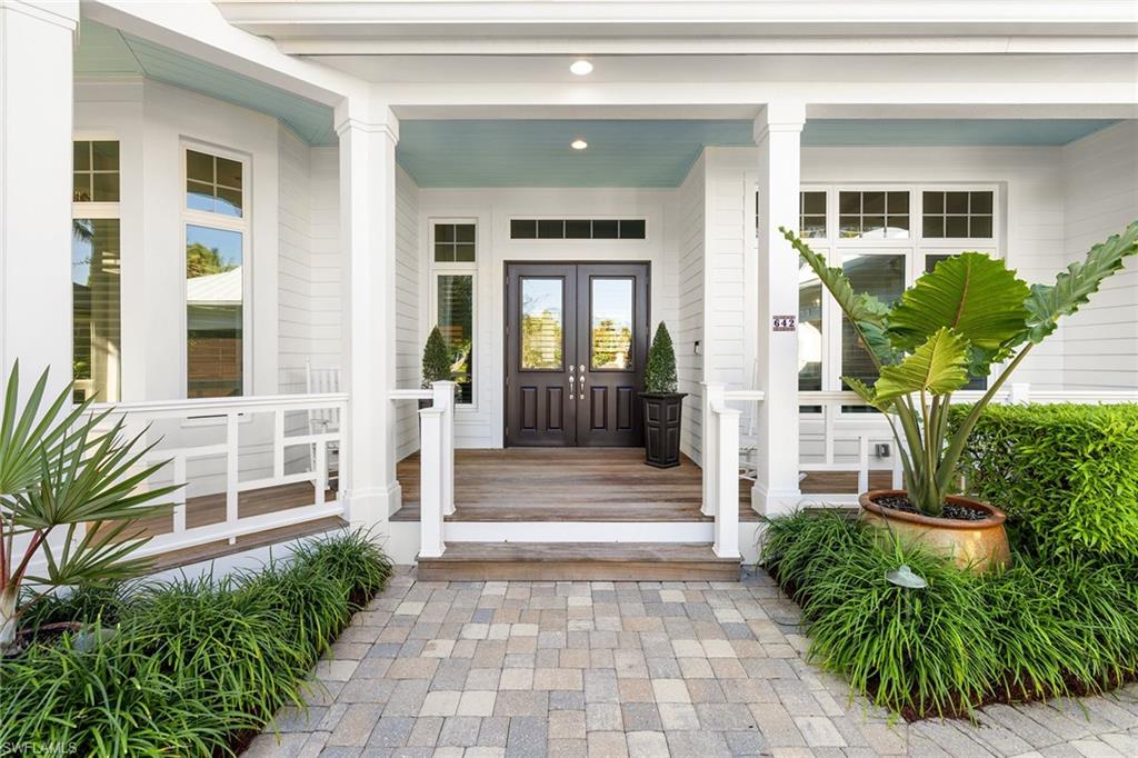 642 Bougainvillea Road Naples, FL 34102 - Photo 3 of 50 View of exterior entry featuring a porch