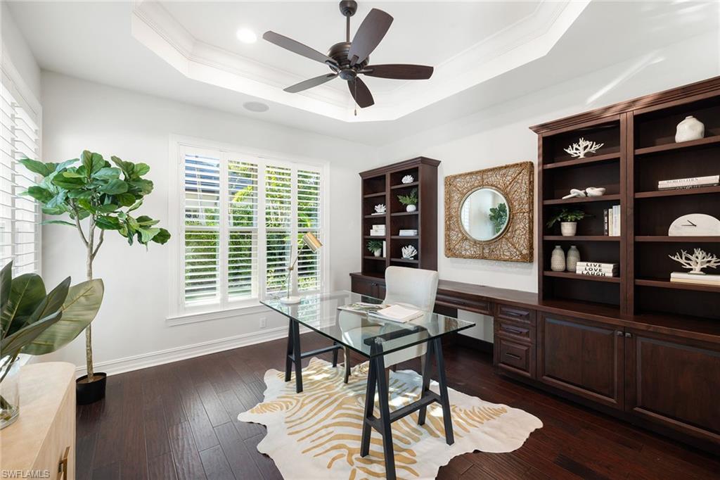 642 Bougainvillea Road Naples, FL 34102 - Photo 30 of 50 Home office with crown molding, ceiling fan, dark wood-style flooring, and a tray ceiling