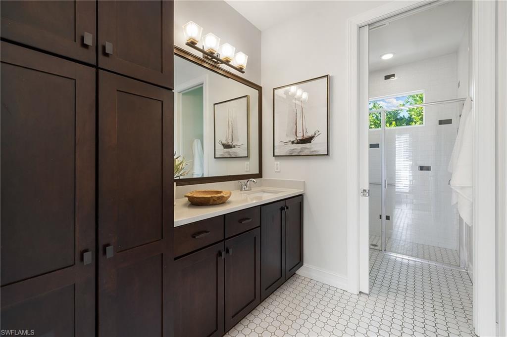 642 Bougainvillea Road Naples, FL 34102 - Photo 32 of 50 Full bathroom with vanity, a stall shower, and light tile patterned floors