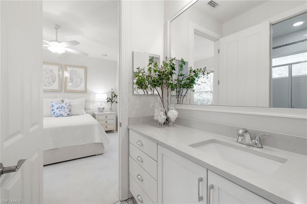 642 Bougainvillea Road Naples, FL 34102 - Photo 36 of 50 Ensuite bathroom featuring vanity, light carpet, and a ceiling fan